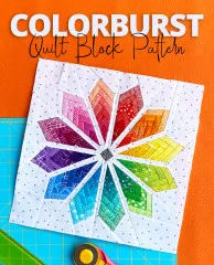 Foundation-Paper-Piecing-Quiltblock in Form eines achtzackigen Regenbogen-Blütensterns auf weißem gepunktetem Stoff, mit Rollschneider und Schneidematte.
